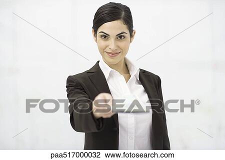 Woman holding out document, smiling at camera, personal perspective View Large Photo Image Stock Image - Woman holding out document, smiling at camera, personal perspective. Fotosearch