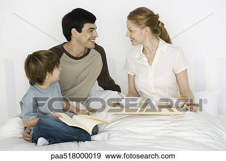 Father and son giving mother breakfast in bed View Large Photo Image Stock Photo - Father and son giving mother breakfast in bed. Fotosearch