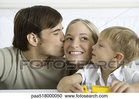 Man kissing wife on the cheek, young son watching View Large Photo Image Stock Image - Man kissing wife on the cheek, young son watching. Fotosearch