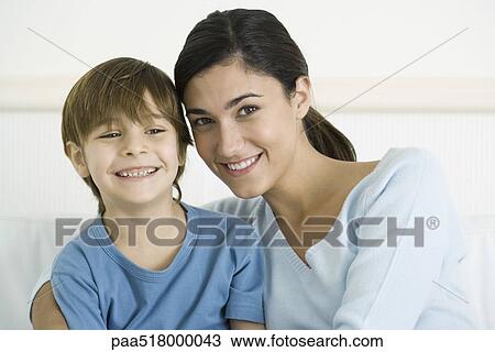 Mother embracing son, smiling, portrait View Large Photo Image Stock Image - Mother embracing son, smiling, portrait. Fotosearch