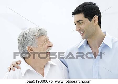 Adult son with arm around father's shoulder, both smiling at one another View Large Photo Image Stock Photography - Adult son with arm around father's shoulder, both smiling at one another. Fotosearch