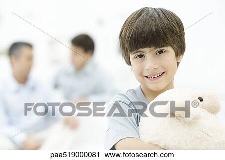 Boy holding stuffed toy, smiling, portrait View Large Photo Image Stock Image - Boy holding stuffed toy, smiling, portrait. Fotosearch