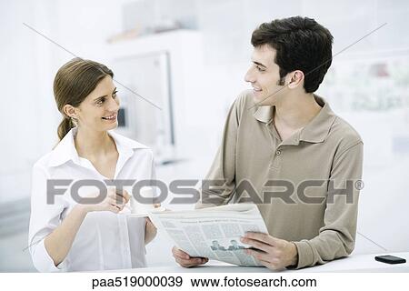 Couple smiling at each other, man holding newspaper, woman holding coffee cup View Large Photo Image Stock Photo - Couple smiling at each other, man holding newspaper, woman holding coffee cup. Fotosearch
