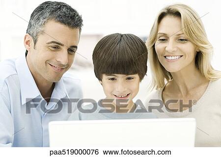 Family using laptop computer together, smiling View Large Photo Image Stock Photograph - Family using laptop computer together, smiling. Fotosearch