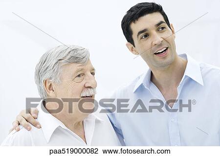 Father and adult son looking away, smiling, son's arm around father's shoulder View Large Photo Image Stock Image - Father and adult son looking away, smiling, son's arm around father's shoulder. Fotosearch