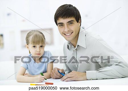 Father and daughter coloring with crayons, looking at camera View Large Photo Image Stock Image - Father and daughter coloring with crayons, looking at camera. Fotosearch