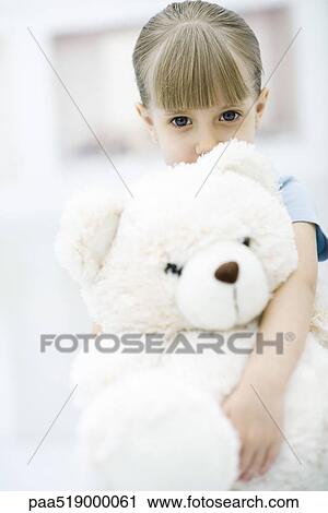 Little girl holding large teddy bear, portrait View Large Photo Image Stock Image - Little girl holding large teddy bear, portrait. Fotosearch