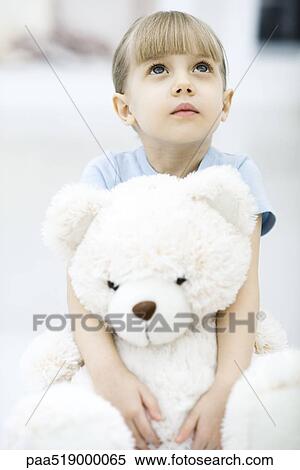 little girl holding a teddy bear