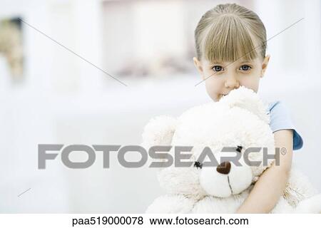 Little girl holding teddy bear, portrait View Large Photo Image Stock Photo - Little girl holding teddy bear, portrait. Fotosearch