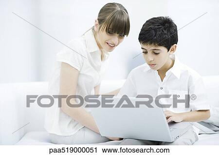 Mother and son looking at laptop computer together View Large Photo Image Stock Image - Mother and son looking at laptop computer together. Fotosearch