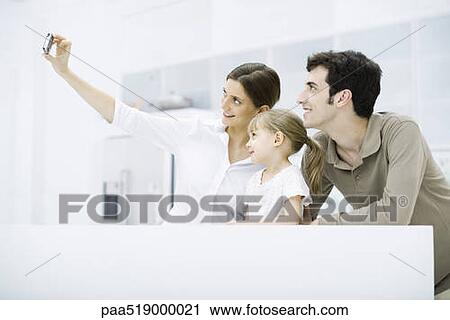 Woman photographing self with husband and daughter View Large Photo Image Stock Image - Woman photographing self with husband and daughter. Fotosearch