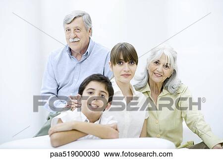 Stock Image - Woman with senior parents and preteen son, portrait. Fotosearch