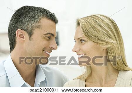 Couple smiling at each other View Large Photo Image Stock Image - Couple smiling at each other. Fotosearch