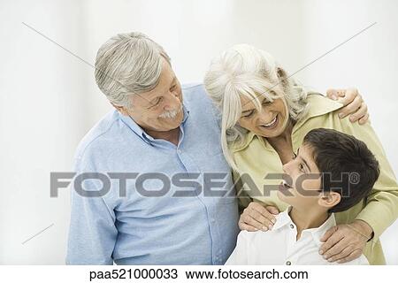 Grandparents and grandson smiling at each other, portrait View Large Photo Image Stock Image - Grandparents and grandson smiling at each other, portrait. Fotosearch