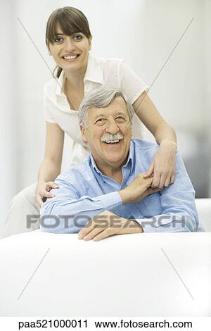 Senior man and adult daughter holding hands, smiling at camera, portrait View Large Photo Image Stock Image - Senior man and adult daughter holding hands, smiling at camera, portrait. Fotosearch