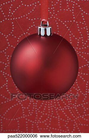 Red Christmas tree ornament hanging from red ribbon View Large Photo Image Stock Photograph - Red Christmas tree ornament hanging from red ribbon. Fotosearch