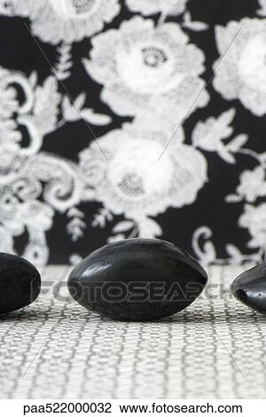 Three polished pebbles in row against patterned background, cropped View Large Photo Image Stock Image - Three polished pebbles in row against patterned background, cropped. Fotosearch