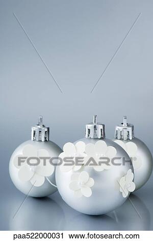 Three silver Christmas tree ornaments decorated with white flowers View Large Photo Image Stock Image - Three silver Christmas tree ornaments decorated with white flowers. Fotosearch