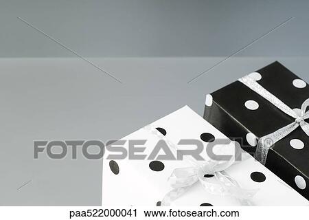 Two black and white polka dotted gift wrapped presents View Large Photo Image Stock Image - Two black and white polka dotted gift wrapped presents. Fotosearch