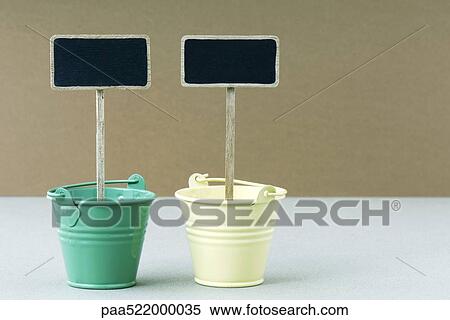 Stock Photography - Two dessert buckets with decorative signs, side by side. Fotosearch
