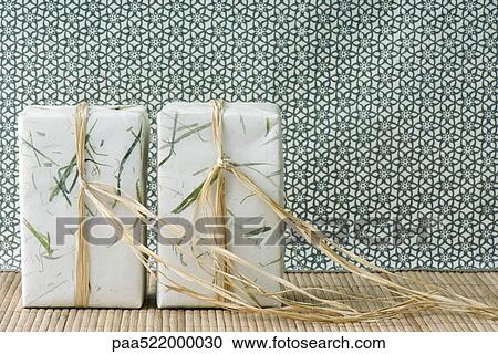 Two gift-wrapped presents side by side, standing on end View Large Photo Image Stock Image - Two gift-wrapped presents side by side, standing on end. Fotosearch