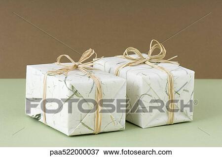 Two gift wrapped presents side by side View Large Photo Image Stock Photo - Two gift wrapped presents side by side . Fotosearch