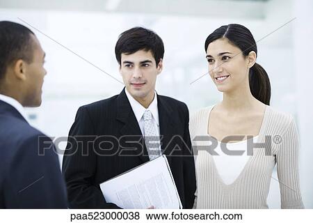 Professional woman chatting with male colleagues View Large Photo Image Stock Photo - Professional woman chatting with male colleagues. Fotosearch