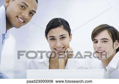 Young professionals smiling at camera, portrait View Large Photo Image Stock Photo - Young professionals smiling at camera, portrait. Fotosearch