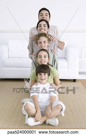 Family lined up shortest to tallest, smiling at camera View Large Photo Image Stock Image - Family lined up shortest to tallest, smiling at camera. Fotosearch