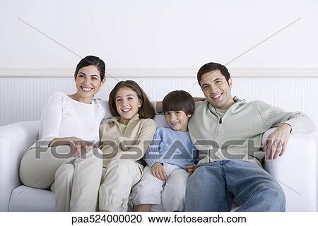 Family sitting together on sofa, smiling View Large Photo Image Stock Image - Family sitting together on sofa, smiling. Fotosearch
