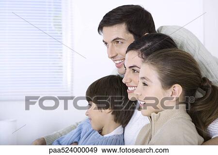Family smiling at looking away together, side view View Large Photo Image Stock Photo - Family smiling at looking away together, side view. Fotosearch