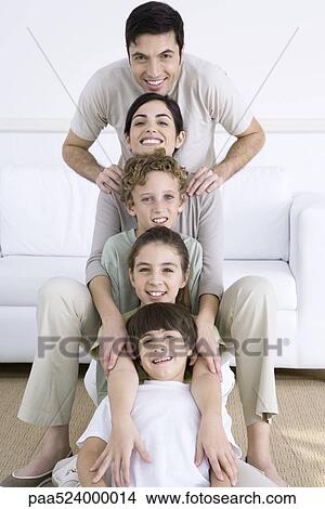 Picture - Portrait of family lined up one behind the other, shortest to tallest. Fotosearch