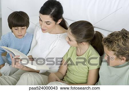 Woman reading story to her children View Large Photo Image Stock Image - Woman reading story to her children. Fotosearch