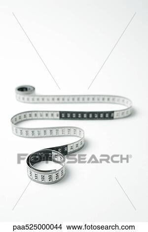 Measuring tape coiled in snakelike manor View Large Photo Image Picture - Measuring tape coiled in snakelike manor. Fotosearch