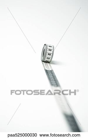 Measuring tape unrolling, focus on background View Large Photo Image Stock Image - Measuring tape unrolling, focus on background. Fotosearch
