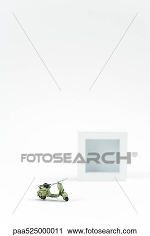 Miniature scooter parked with square object in background View Large Photo Image Stock Image - Miniature scooter parked with square object in background. Fotosearch