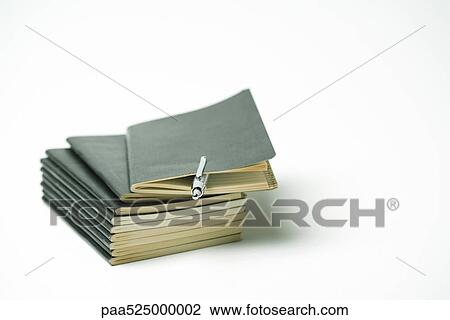 Stack of little black books, ball point pen clipped within cover of top book View Large Photo Image Stock Image - Stack of little black books, ball point pen clipped within cover of top book. Fotosearch