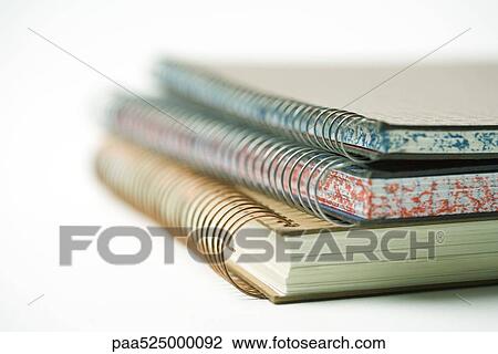Stacked spiral notebooks, close-up View Large Photo Image Stock Image - Stacked spiral notebooks, close-up. Fotosearch