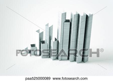 Stock Photo - Strips of staples standing on end mimicking skyscrapers. Fotosearch