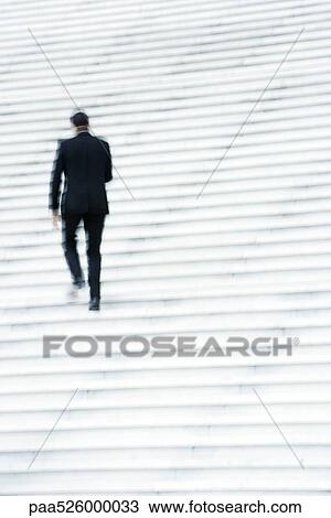 Businessman ascending stairs outdoors View Large Photo Image Stock Image - Businessman ascending stairs outdoors. Fotosearch