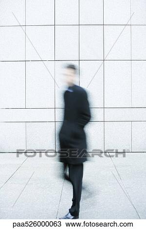 Businessman hurrying down sidewalk View Large Photo Image Stock Image - Businessman hurrying down sidewalk. Fotosearch
