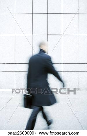 Businessman hurrying down sidewalk View Large Photo Image Stock Photo - Businessman hurrying down sidewalk. Fotosearch