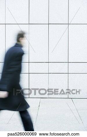 Businessman hurrying down sidewalk View Large Photo Image Stock Photo - Businessman hurrying down sidewalk. Fotosearch