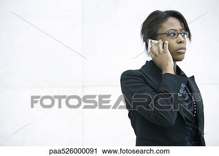 Businesswoman using cell phone, looking away View Large Photo Image Stock Image - Businesswoman using cell phone, looking away. Fotosearch
