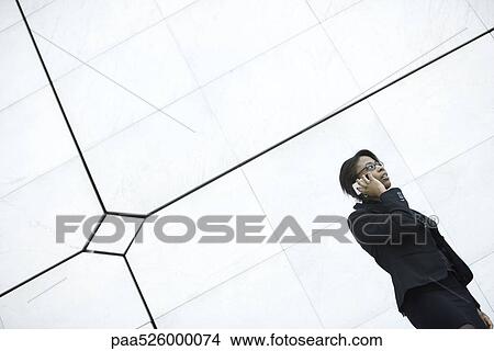 Picture - Businesswoman using cell phone. Fotosearch