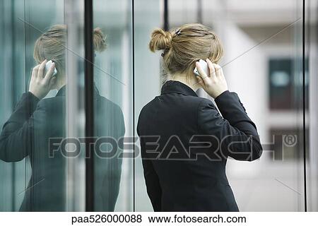 Businesswoman using cell phone, rear view View Large Photo Image Stock Photo - Businesswoman using cell phone, rear view. Fotosearch