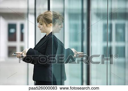 Businesswoman using cell phone View Large Photo Image Stock Image - Businesswoman using cell phone. Fotosearch