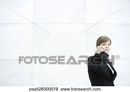 Businesswoman using cell phone View Large Photo Image Stock Photo - Businesswoman using cell phone. Fotosearch