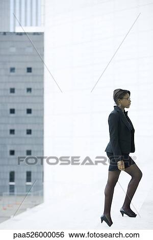 Businesswoman walking up steps View Large Photo Image Stock Photograph - Businesswoman walking up steps. Fotosearch