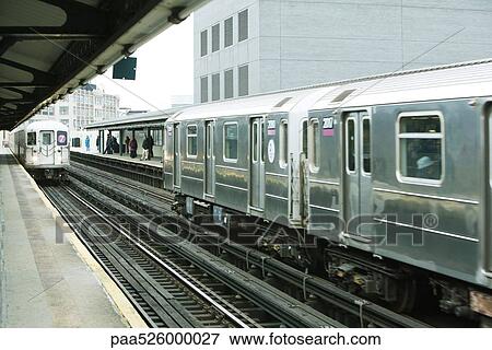 Commuters waiting for subway on elevated train platform, IRT Flushing Line of New York City Subway View Large Photo Image Stock Photo - Commuters waiting for subway on elevated train platform, IRT Flushing Line of New York City Subway. Fotosearch